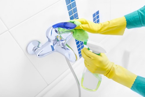Professional cleaner maintaining safe working conditions in a property